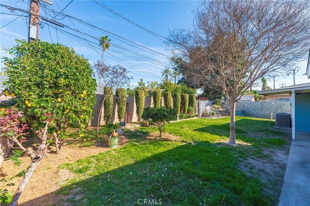 view of yard featuring fence and central air condition unit