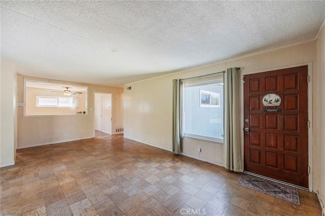 entryway with visible vents, a healthy amount of sunlight, and a textured ceiling