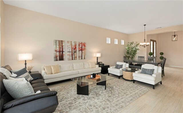 82745 Odlum Dr, Indio, CA 92201 - living area with a chandelier and light wood-style flooring
