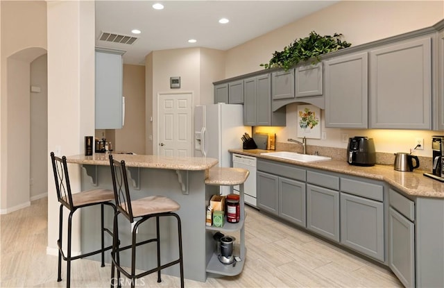 82745 Odlum Dr, Indio, CA 92201 - kitchen featuring gray cabinets, white appliances, a peninsula, and recessed lighting