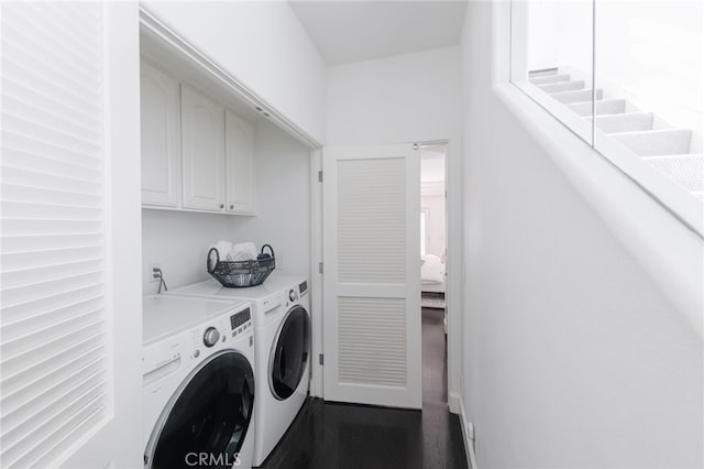 laundry room featuring cabinet space and separate washer and dryer