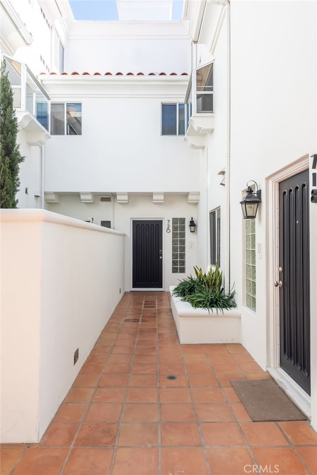 doorway to property featuring stucco siding