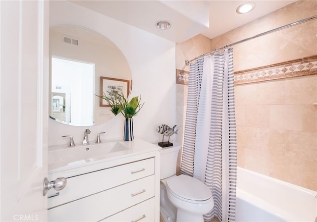 full bathroom featuring shower / bath combo with shower curtain, visible vents, toilet, and vanity