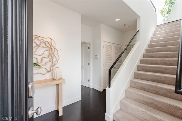 foyer entrance featuring recessed lighting, baseboards, wood finished floors, and stairs