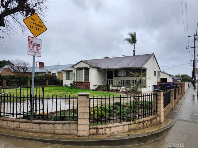 view of front of house with a front lawn and a fenced front yard