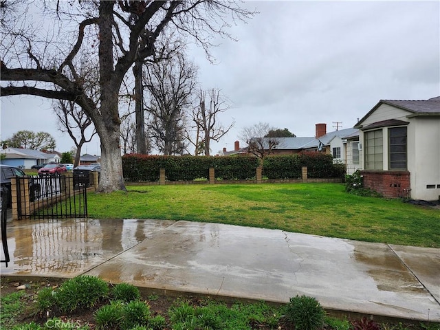 view of yard featuring fence and a patio