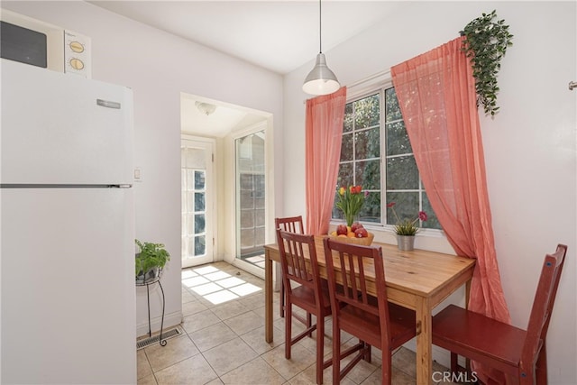 dining space featuring light tile patterned flooring and visible vents