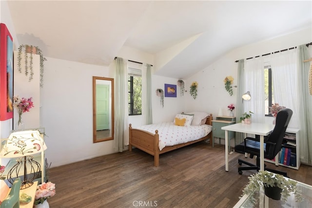 bedroom with lofted ceiling and wood finished floors