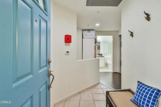 foyer entrance with baseboards, visible vents, and light tile patterned flooring