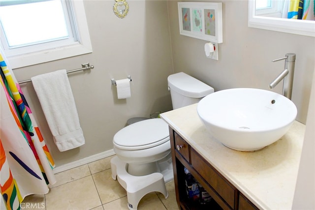 bathroom with tile patterned flooring, toilet, vanity, and baseboards