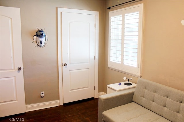 interior space with dark wood-style floors and baseboards