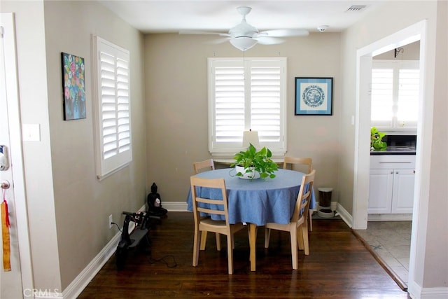 dining area featuring visible vents, plenty of natural light, wood finished floors, and a ceiling fan