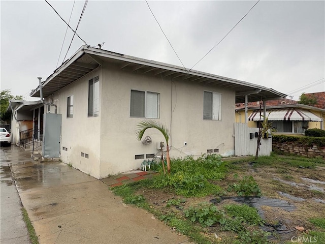 view of property exterior featuring crawl space and stucco siding