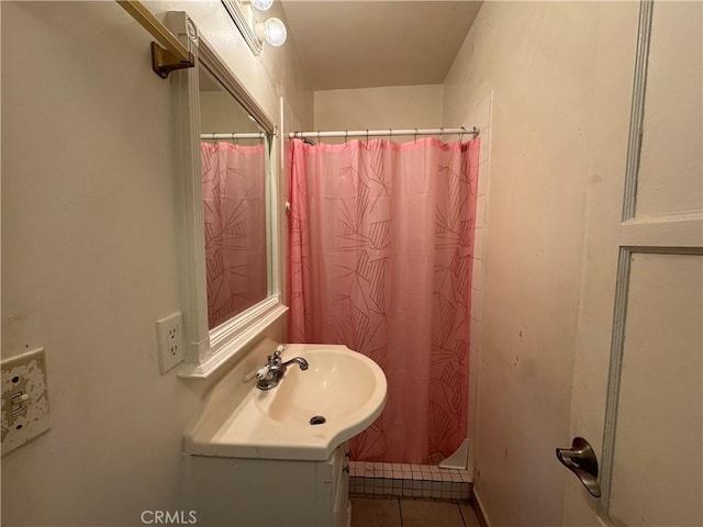 bathroom with tile patterned floors, a shower with shower curtain, and vanity