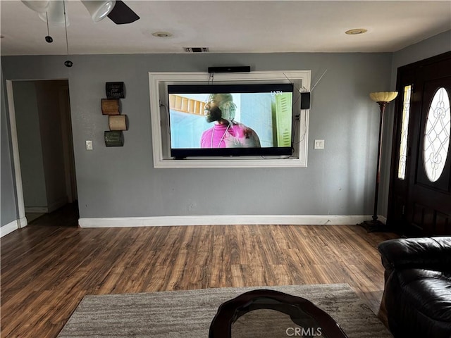 foyer entrance featuring visible vents, a healthy amount of sunlight, baseboards, and wood finished floors