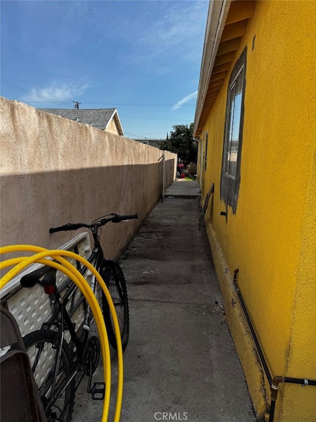 view of home's exterior featuring fence and stucco siding