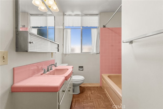 full bathroom with toilet, vanity, and bathing tub / shower combination