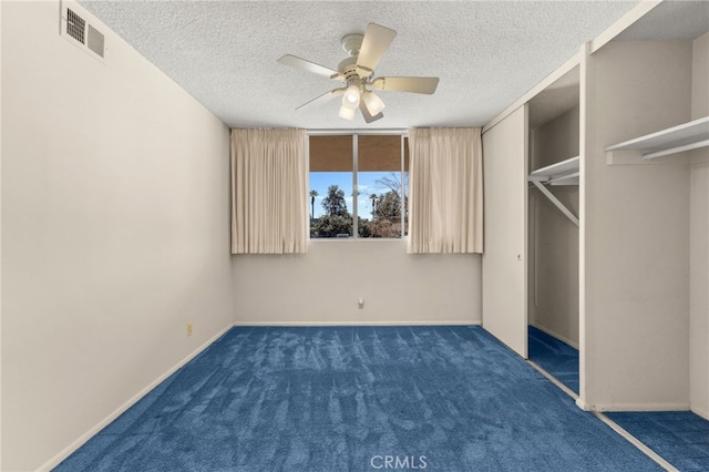 unfurnished bedroom with baseboards, visible vents, carpet floors, and a textured ceiling