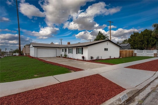 ranch-style house featuring driveway, a front yard, fence, and stucco siding