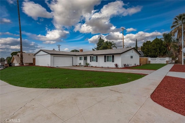 ranch-style house with an attached garage, fence, and a front yard