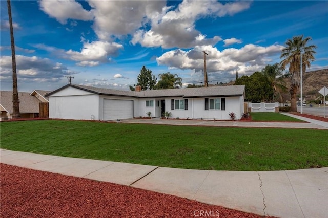 single story home featuring a garage, a front lawn, fence, and stucco siding