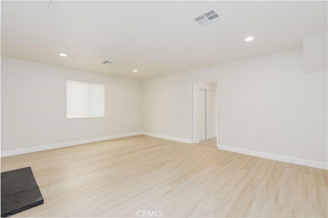 spare room featuring baseboards, recessed lighting, visible vents, and light wood-style floors