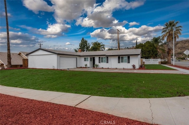 ranch-style home featuring a garage, stucco siding, fence, and a front yard