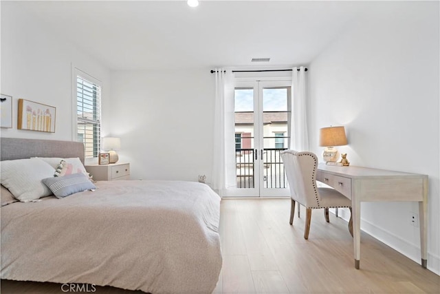 bedroom with visible vents, light wood-style flooring, french doors, and access to outside