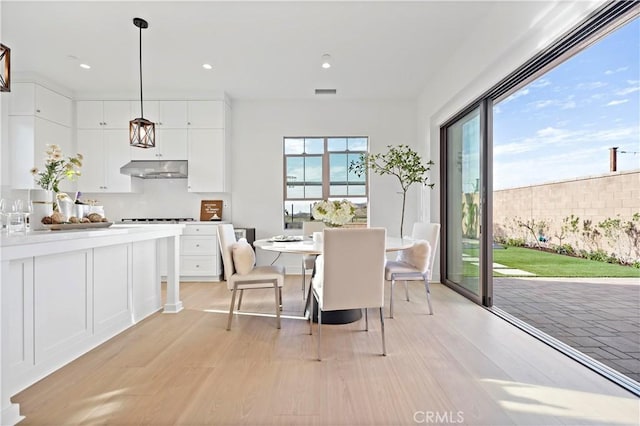 dining room featuring plenty of natural light, light wood-style floors, and visible vents