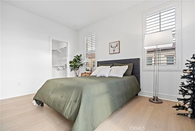 bedroom featuring baseboards and wood finished floors