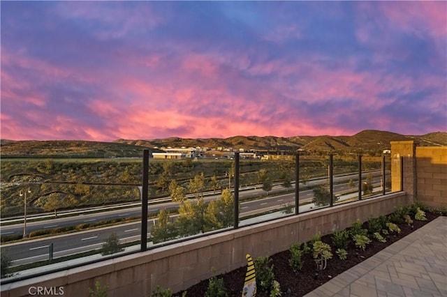 exterior space with a mountain view and fence