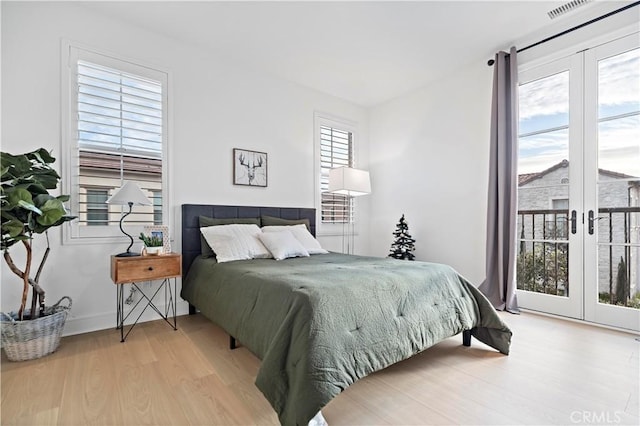 bedroom featuring french doors and wood finished floors