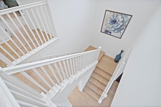 stairway with wood finished floors