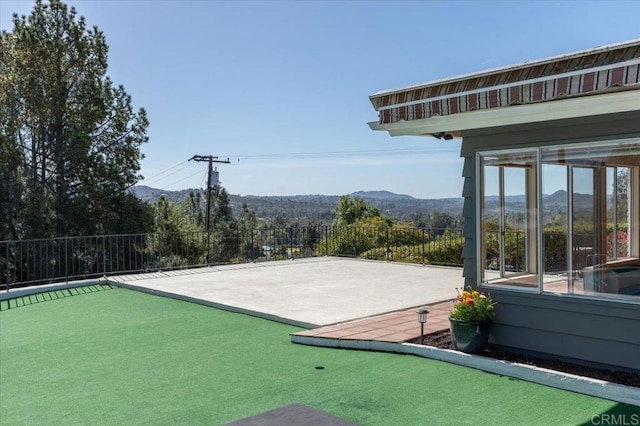 exterior space featuring a mountain view and fence