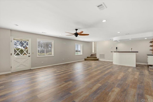 unfurnished living room with recessed lighting, visible vents, baseboards, and wood finished floors