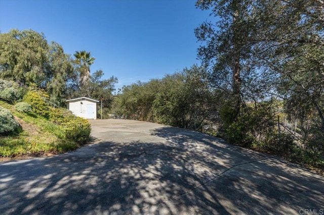 view of street featuring concrete driveway