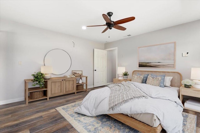 bedroom with a ceiling fan, wood finished floors, visible vents, and baseboards