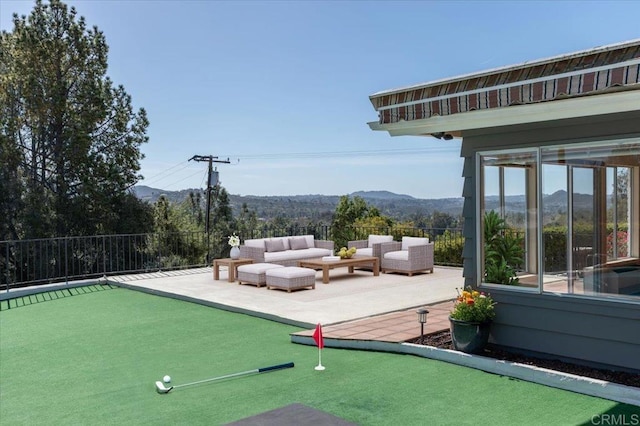 exterior space featuring a patio area, a mountain view, fence, and an outdoor hangout area