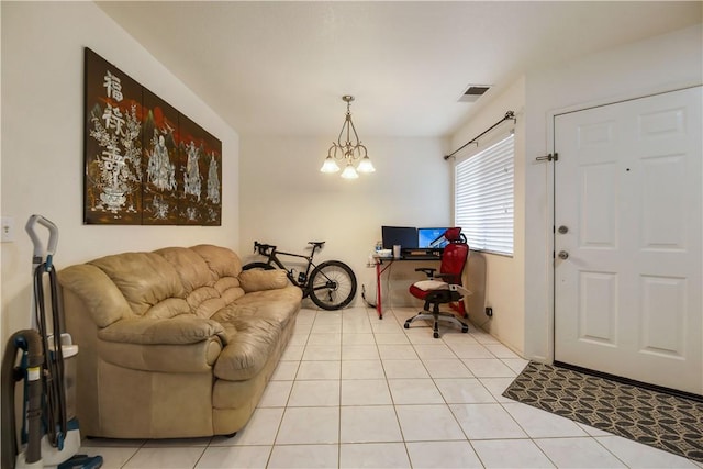 living room with light tile patterned floors, visible vents, and a notable chandelier