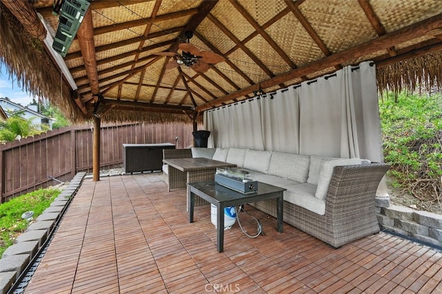 view of patio featuring ceiling fan, a fenced backyard, an outdoor hangout area, and a gazebo