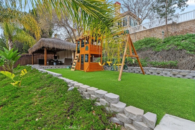 view of playground with a yard and a fenced backyard