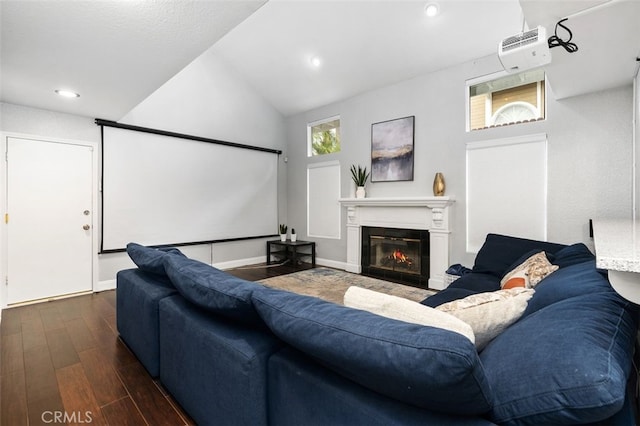 living room with baseboards, a glass covered fireplace, wood finished floors, vaulted ceiling, and recessed lighting