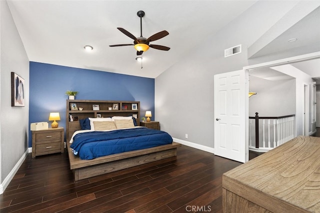 bedroom featuring vaulted ceiling, wood finished floors, visible vents, and baseboards