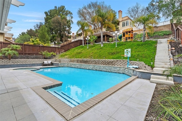 view of swimming pool featuring a fenced backyard, stairs, a lawn, a fenced in pool, and a patio area