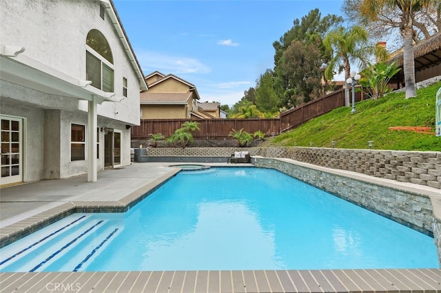 view of pool featuring a yard, a fenced backyard, a fenced in pool, and a patio