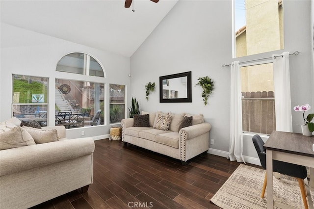 living room featuring baseboards, high vaulted ceiling, ceiling fan, and dark wood-type flooring