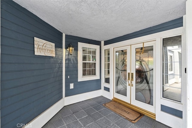 view of exterior entry featuring french doors