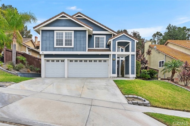 view of front facade featuring driveway, a front lawn, an attached garage, and fence