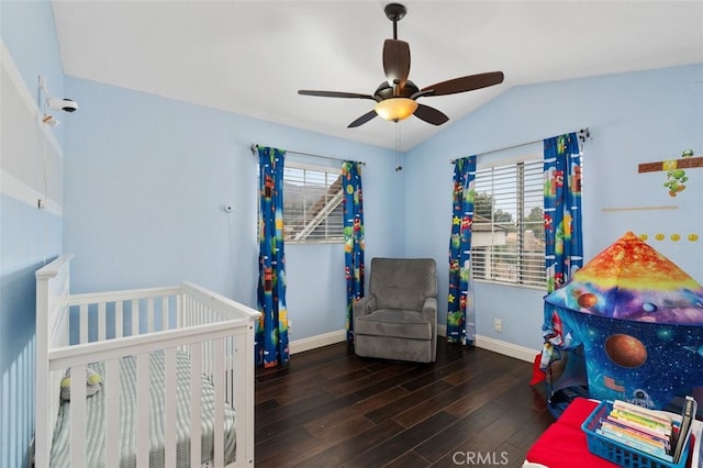 bedroom with multiple windows, baseboards, and wood finished floors