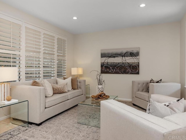 living area with tile patterned floors, baseboards, and recessed lighting